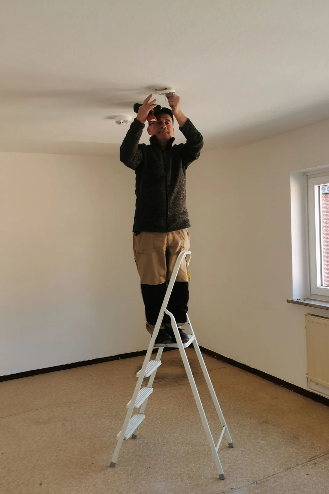 Fitting a ceiling detector from a step ladder, for ceiling fan installation in Oakville