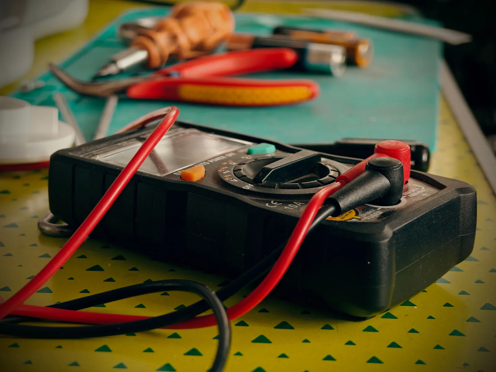 A multimeter and hand tools ready for a diagnostic visit, for electrician in Oakville